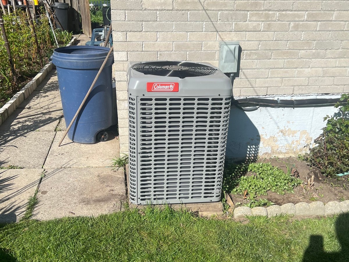 Outdoor central AC condenser diagnostic work by OLU HVAC.
