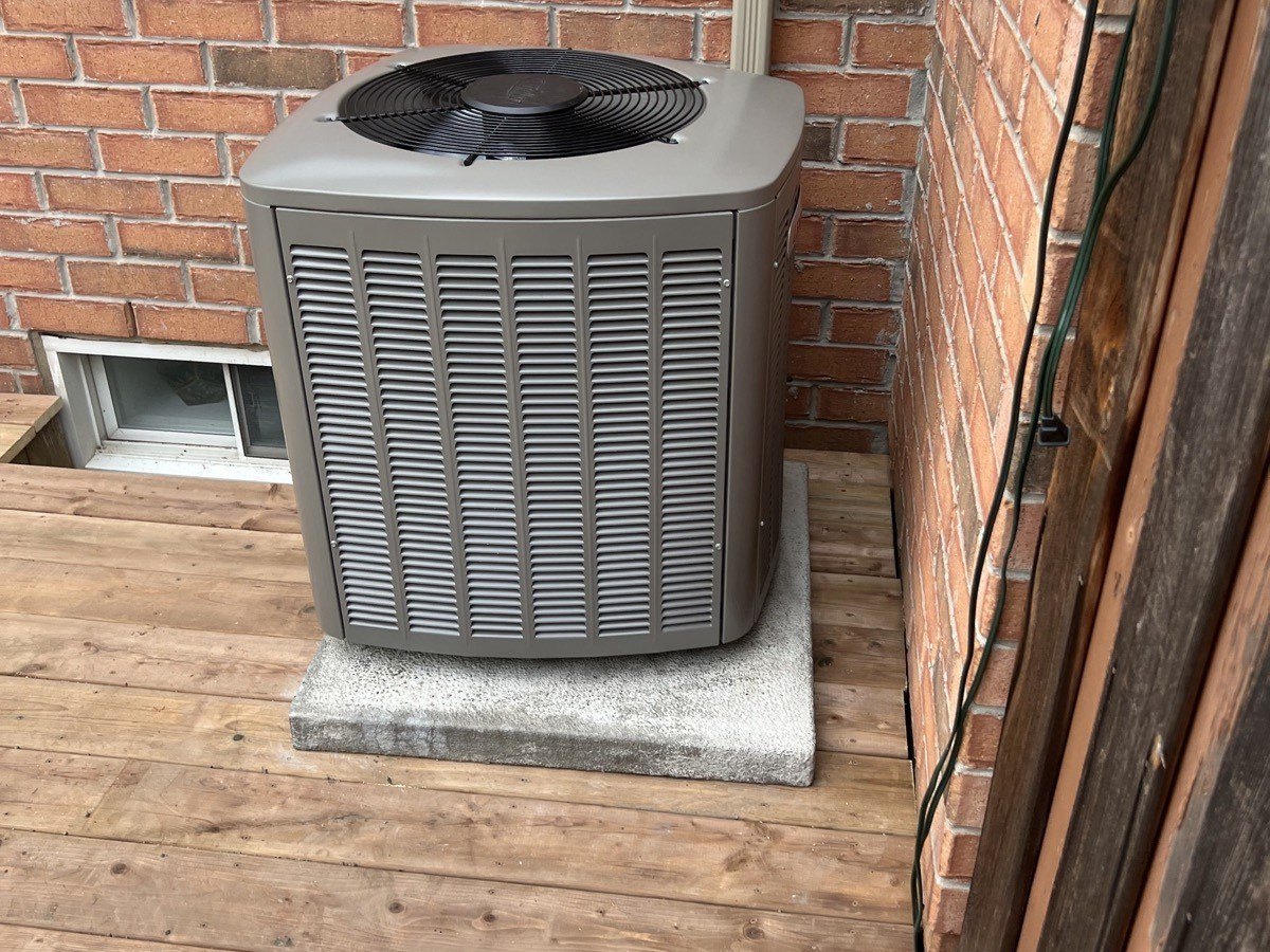 Residential AC condenser checked during seasonal cooling maintenance.