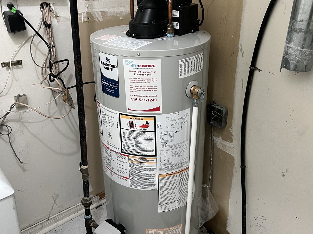 Tank water heater installation work for a home mechanical room.