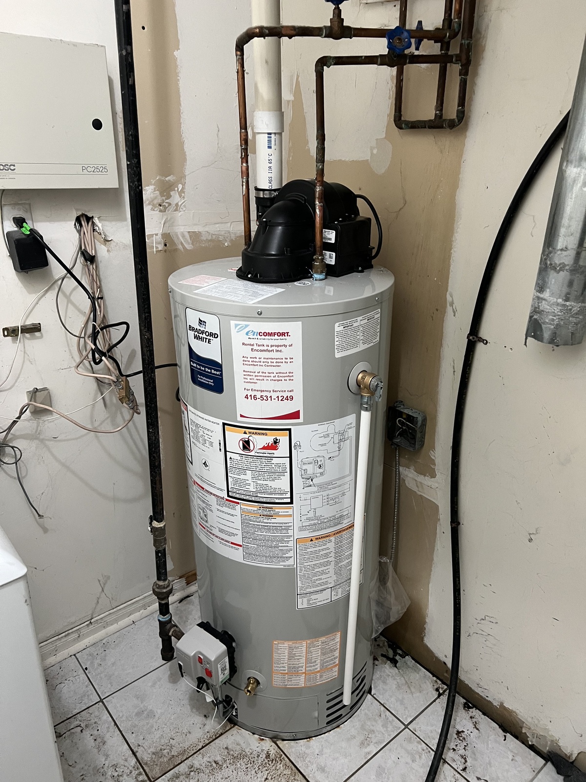 Tank water heater installation work for a home mechanical room.