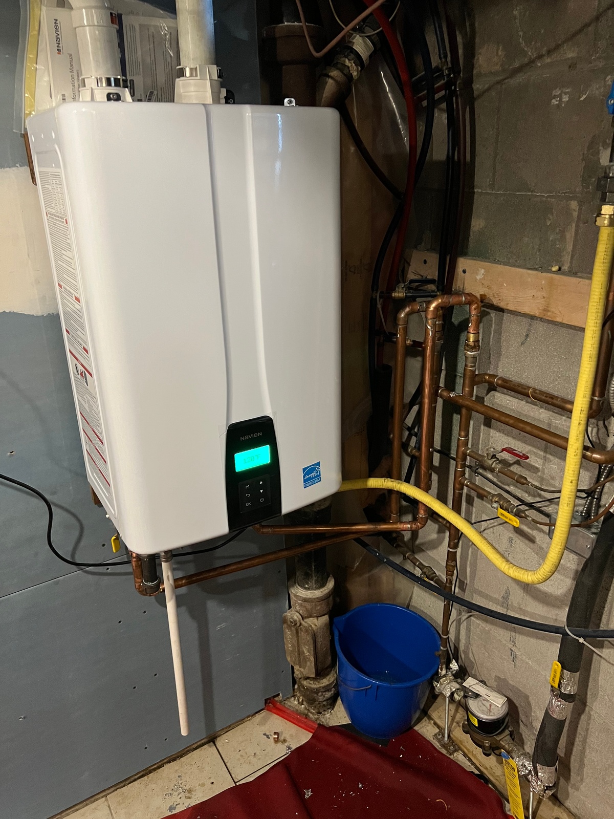 Tankless water heater installation and venting setup.